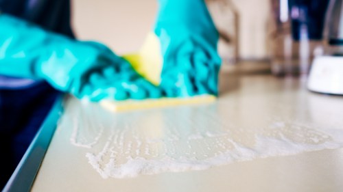 Cleaning staff wearing protective equipment during service